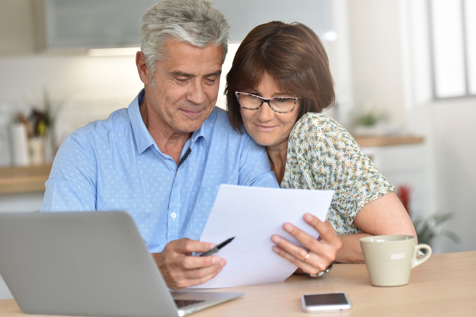 Senior couple using laptop computer at home